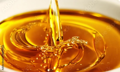 Liquid Gold Pour: A stream of shimmering, golden liquid cascades into a bowl, creating mesmerizing ripples and capturing the essence of indulgence and purity. 