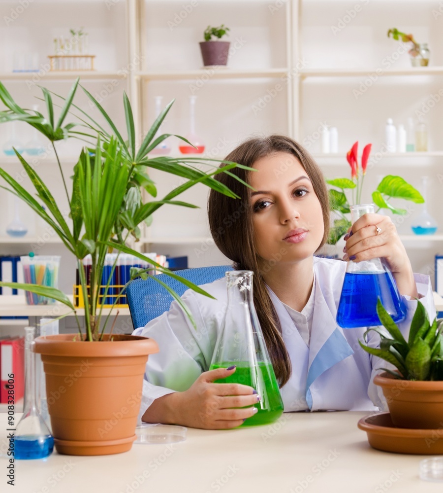 Young beautiful biotechnology chemist working in the lab Young beautiful biotechnology chemist working in the lab