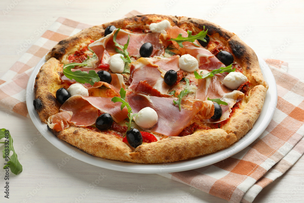 Tasty pizza with cured ham, olives, mozzarella cheese, sun-dried tomato and arugula on light wooden table Tasty pizza with cured ham, olives, mozzarella cheese, sun-dried tomato and arugula on light wooden table