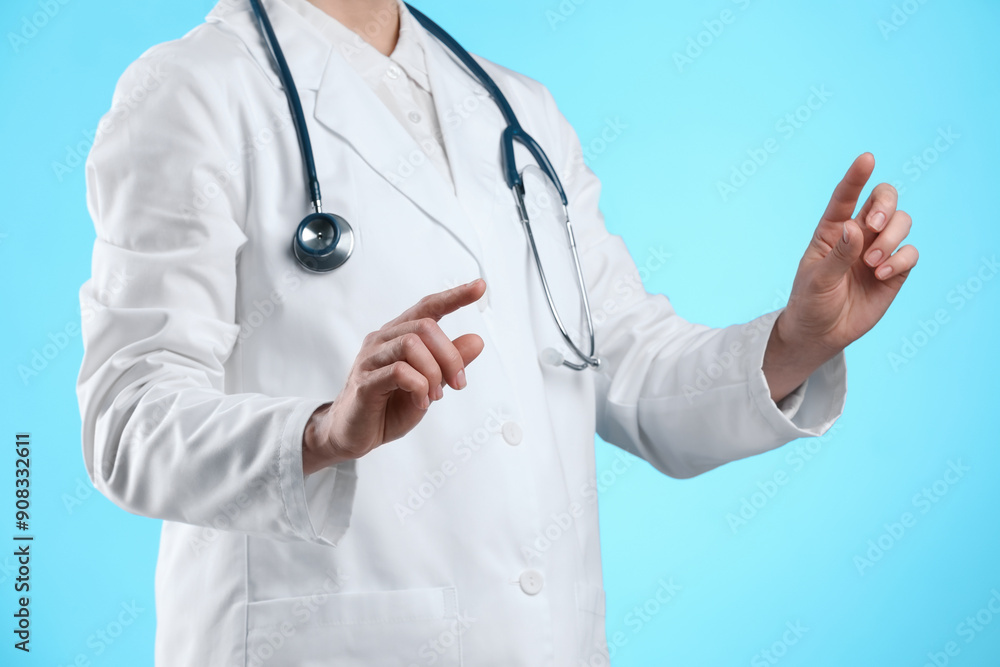 Doctor holding something on light blue background, closeup Doctor holding something on light blue background, closeup