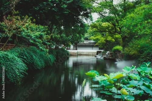 A serene Chinese garden pond with lush greenery and water lilies.