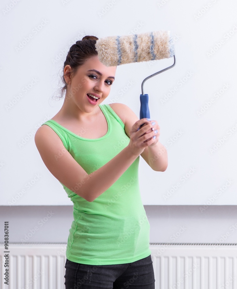 Young beautiful woman doing renovation at home Young beautiful woman doing renovation at home