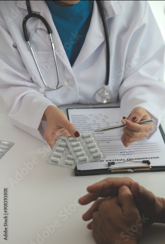 Doctor prescribing medicine giving pills to senior grandmother patient at hospital.