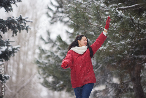 Joyful Woman in Red Jacket Enjoying Snowy Winter Park