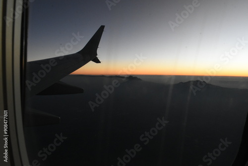 airplane landing at sunset