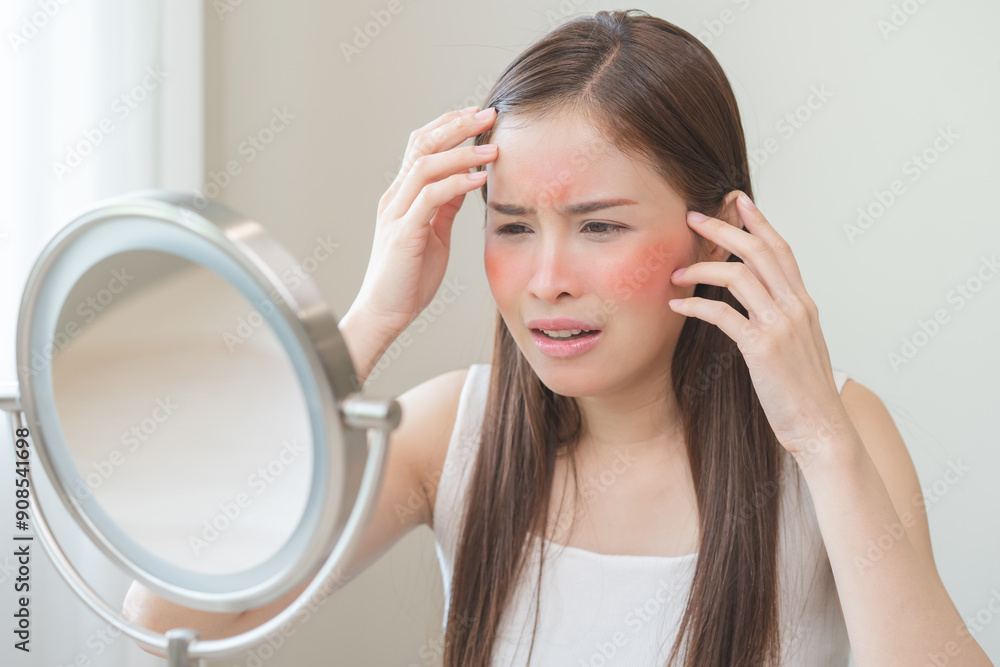Dermatology, scratch asian young woman looking at mirror, expression worry and itch, itchy allergy or allergic sensitive reaction, red spot or rash on her face. Beauty care from skin problem treatment Dermatology, scratch asian young woman looking at mirror, expression worry and itch, itchy allergy or allergic sensitive reaction, red spot or rash on her face. Beauty care from skin problem treatment