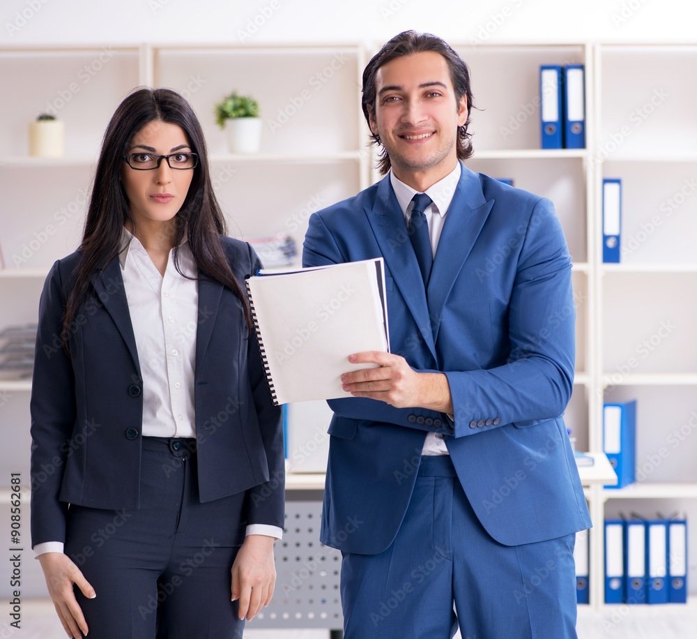 Two employees working in the office Two employees working in the office