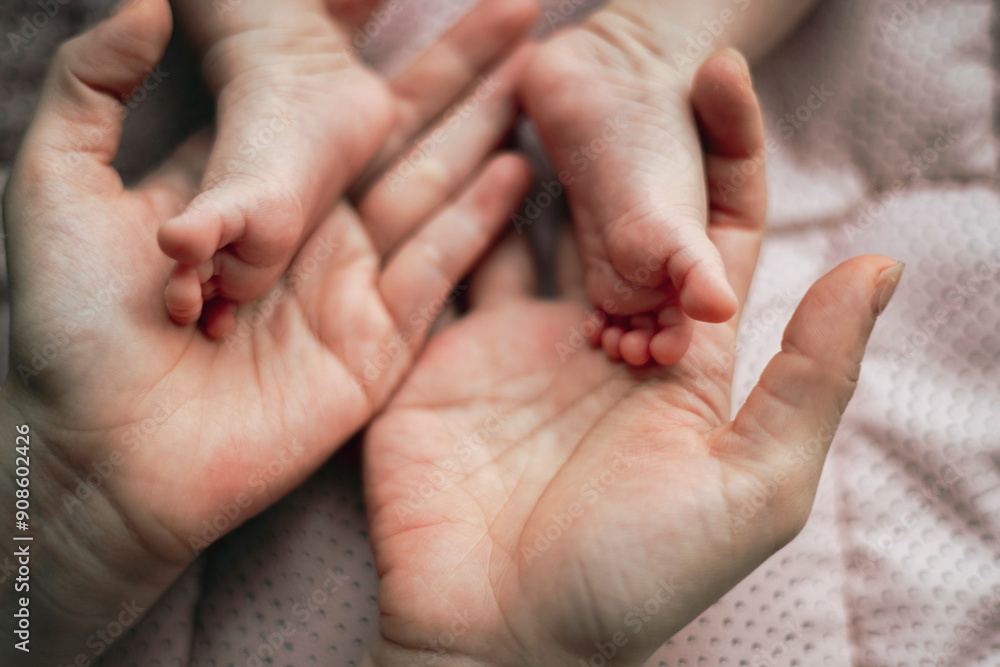 A mother's gentle hands cradle the tiny feet of her newborn baby. The contrast between her hands and the baby's delicate feet highlights the fragility and innocence of new life. A mother's gentle hands cradle the tiny feet of her newborn baby. The contrast between her hands and the baby's delicate feet highlights the fragility and innocence of new life.