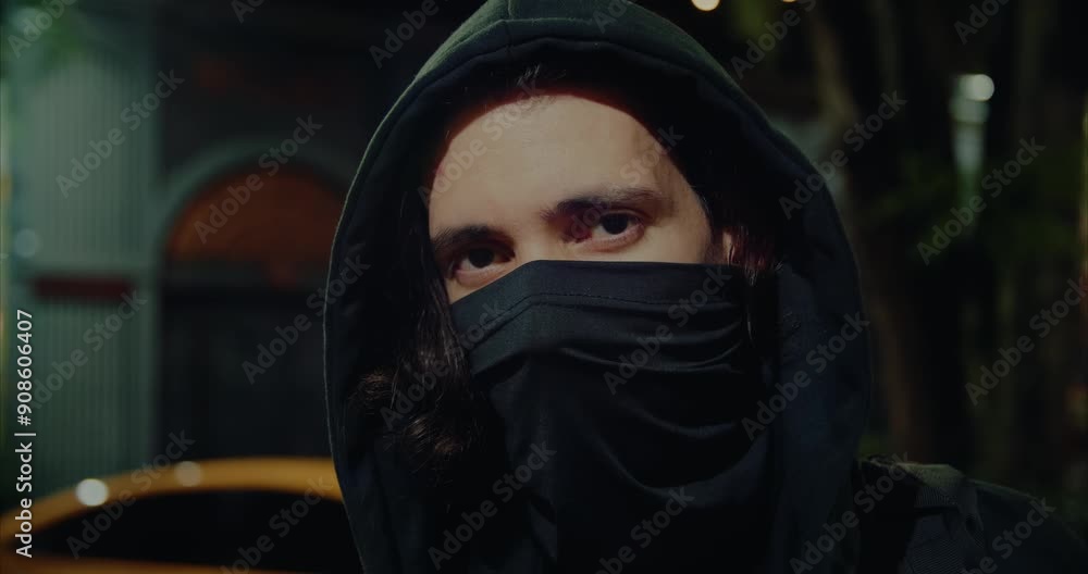 Mysterious man with hoodie looking to the camera Mysterious man with hoodie looking to the camera