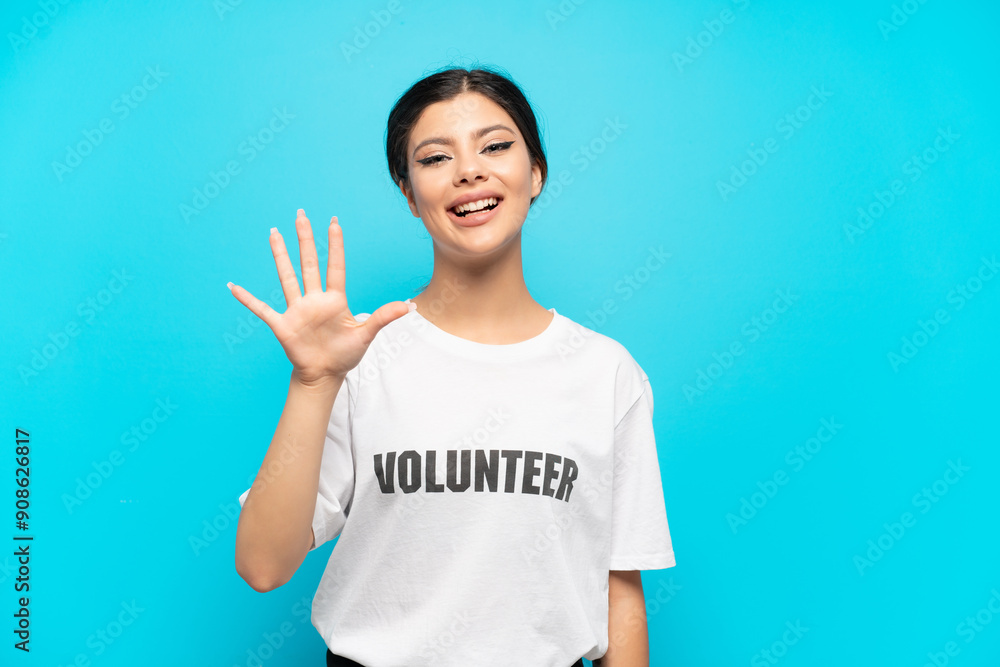 Young Russian volunteer girl isolated on blue background counting five with fingers Young Russian volunteer girl isolated on blue background counting five with fingers