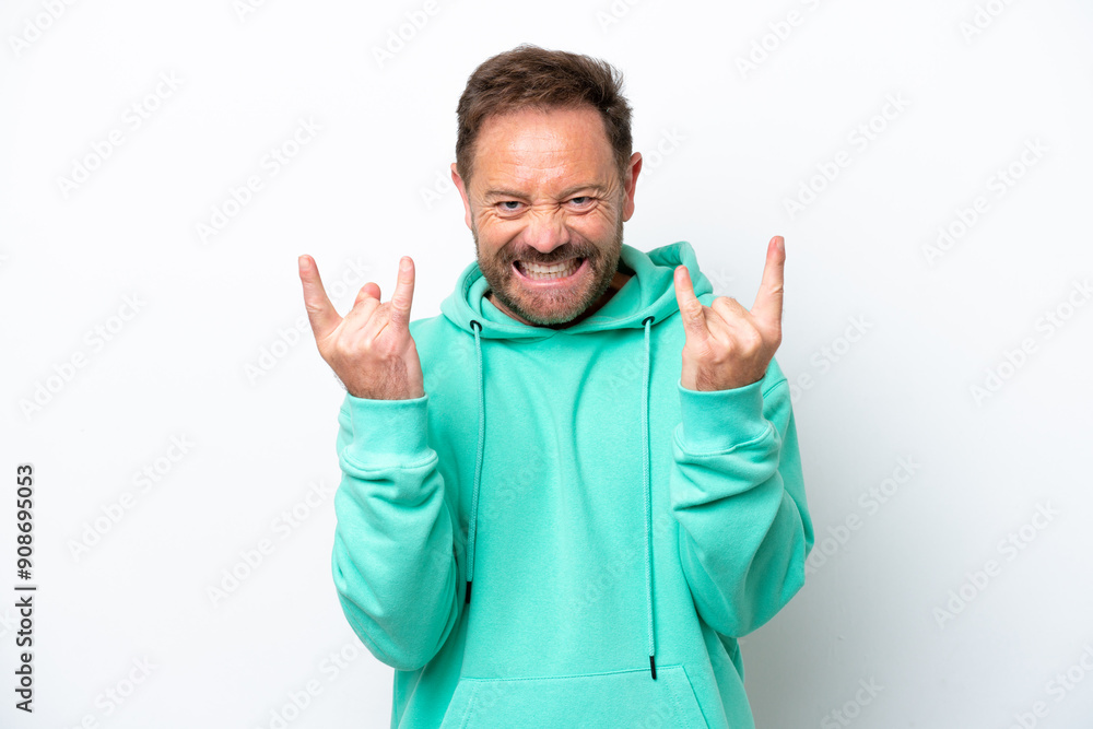 Middle age caucasian man isolated on white background making horn gesture Middle age caucasian man isolated on white background making horn gesture