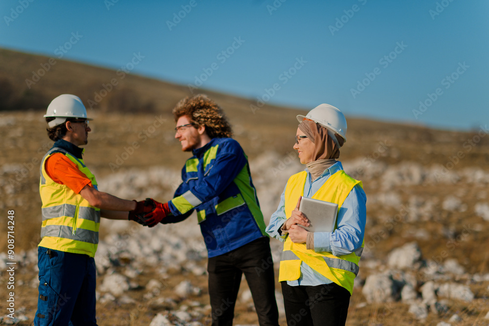 A team of engineers and workers oversees a wind turbine project at a modern wind farm, working together to ensure the efficient generation of renewable energy A team of engineers and workers oversees a wind turbine project at a modern wind farm, working together to ensure the efficient generation of renewable energy