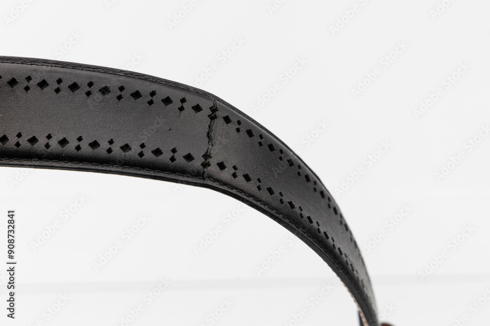 Obraz premium Black broken torn leather belt