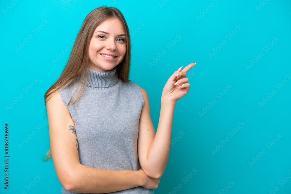 Young Lithuanian woman isolated on blue background pointing finger to the side Young Lithuanian woman isolated on blue background pointing finger to the side