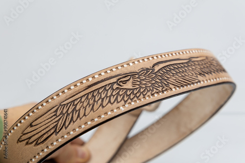 Real natural embossed Leather belt. Leather brown belt on white background, vintage retro leather belt.