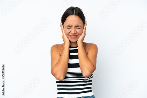 Young hispanic woman isolated on white background frustrated and covering ears photo