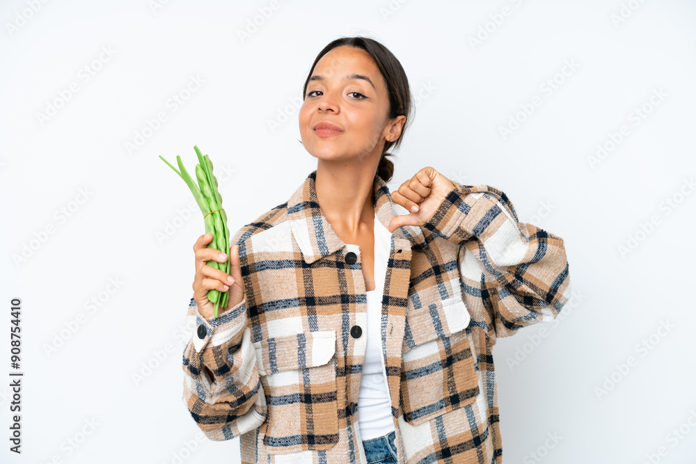 Young hispanic woman holding a green beans isolated on white background proud and self-satisfied Young hispanic woman holding a green beans isolated on white background proud and self-satisfied