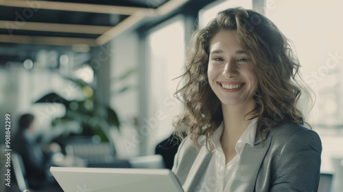 A smiling woman in a white robe enjoys the morning sunlight by a window, radiating happiness and a sense of peaceful contentment.