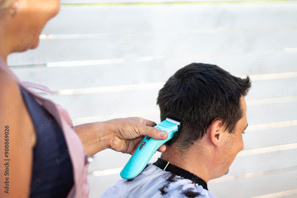 A hairdresser cutting the hair of a dark-haired man. Close-up shots. A hairdresser cutting the hair of a dark-haired man. Close-up shots.