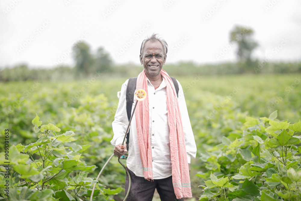 Indian farmer holding spray pump in hand Indian farmer holding spray pump in hand