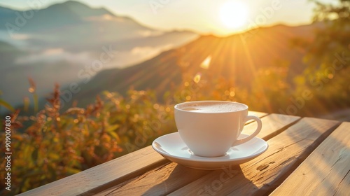 A cup of coffee on a wooden table with a stunning sunrise and mountains in the background. photo