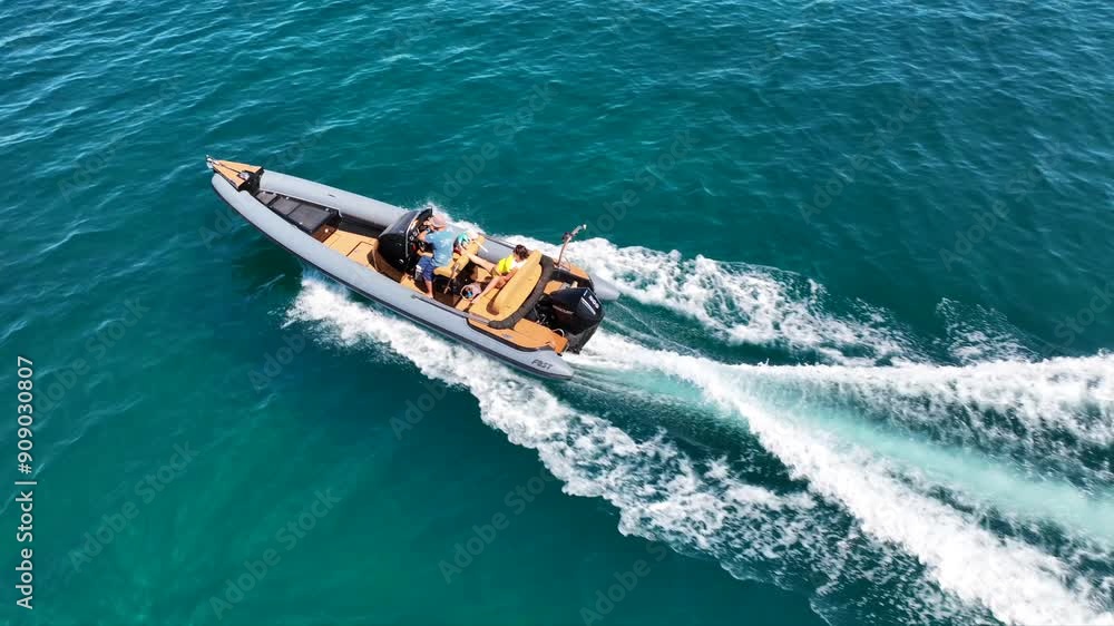 Aerial drone tracking video of luxury inflatable rib speed boat cruising in mediterranean deep blue sea Aerial drone tracking video of luxury inflatable rib speed boat cruising in mediterranean deep blue sea