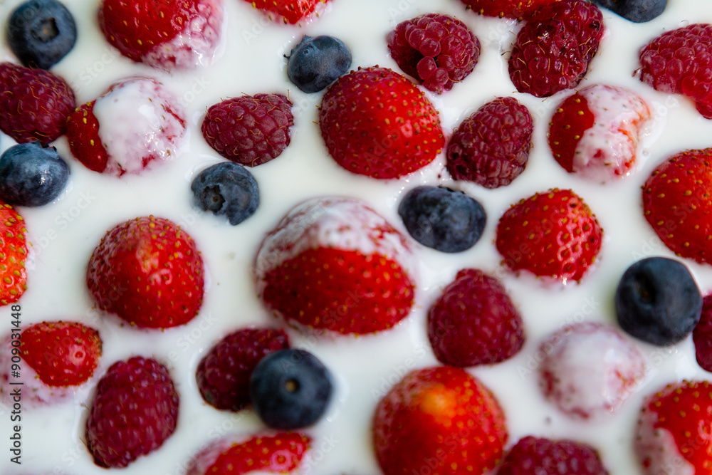 In a plate with freshly whipped cream juicy berries strawberries raspberries and blueberries In a plate with freshly whipped cream juicy berries strawberries raspberries and blueberries