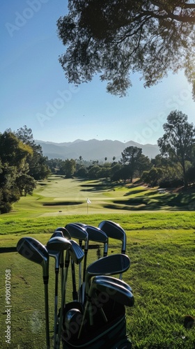 A sunny golf course scene with a Titleist bag, clubs, rolling hills, trees, and a flagstick for the green, set under clear skies with a distant mountain ridge. photo