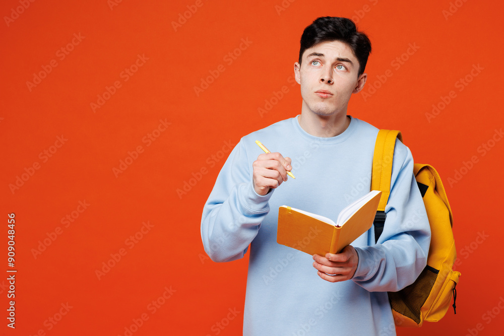 Young minded pensive thoughtful man student wear blue casual clothes backpack bag hold books notebook look aside on area isolated on plain red orange background High school university college concept Young minded pensive thoughtful man student wear blue casual clothes backpack bag hold books notebook look aside on area isolated on plain red orange background High school university college concept