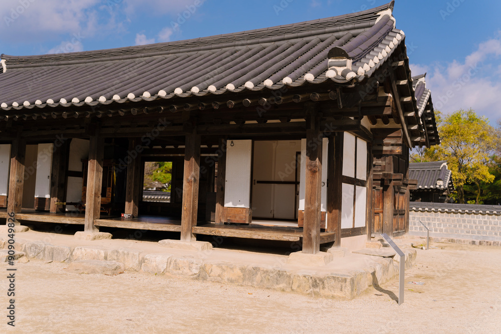 the traditional Korean architecture at Gyeonggijeon Shrine, featuring wooden beams, a tiled roof, and white walls under a clear blue sky. the traditional Korean architecture at Gyeonggijeon Shrine, featuring wooden beams, a tiled roof, and white walls under a clear blue sky.