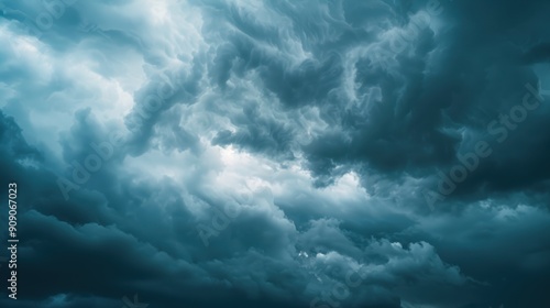 Swirling storm clouds create an ominous atmosphere, casting shadows and showcasing raw beauty in gray and blue hues overhead