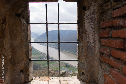 Fenster mit Gitter mit Blick auf die Donau von der Ruine Aggstein aus photo