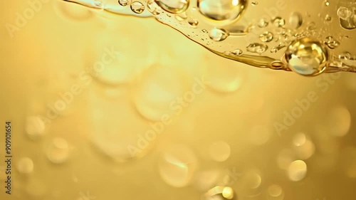 Golden oil droplets isolated on yellow background

