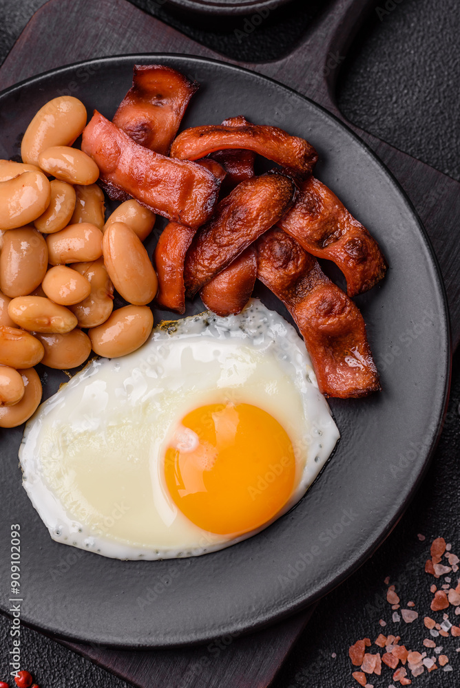 English breakfast with fried eggs, bacon, beans, tomatoes, spices and herbs English breakfast with fried eggs, bacon, beans, tomatoes, spices and herbs
