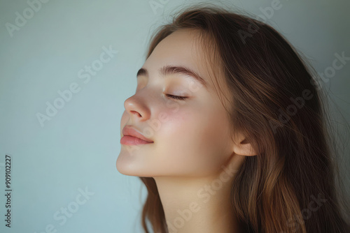 A close up of a girl's face with her eyes closed