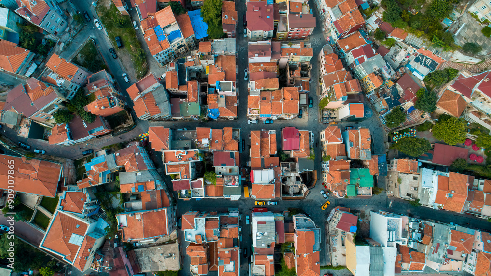 Aerial view of houses in a neighborhood. A photo taken of the red tiles of houses arranged in a certain order. Aerial view of houses in a neighborhood. A photo taken of the red tiles of houses arranged in a certain order.