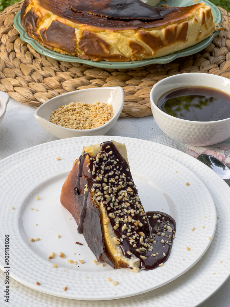 Fototapeta premium Popular Spanish cheesecake called San Sebastian cheesecake., Sliced san sebastian cheesecake with coffee on table