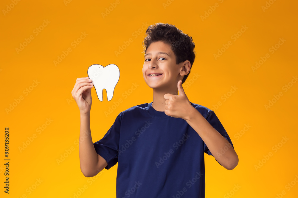 Child boy holding papercraft tooth and showing thumb up gesture. Dental health concept Child boy holding papercraft tooth and showing thumb up gesture. Dental health concept