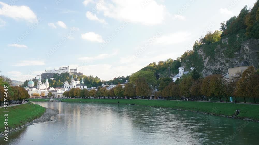A bridge spans a river and connects two cities. The bridge is surrounded by buildings and a hill A bridge spans a river and connects two cities. The bridge is surrounded by buildings and a hill