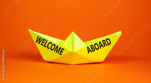 Welcome aboard symbol. Concept words Welcome aboard on beautiful yellow paper boat. Beautiful orange background. Business, motivational welcome aboard concept. Copy space.