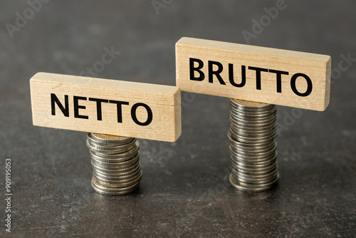 Obraz na płótnie Netto and brutto. Net and gross symbol. Words on wooden cubes set on smaller and larger stack of coins change net to gross. Financial concept, dark wooden background, copy space w salonie