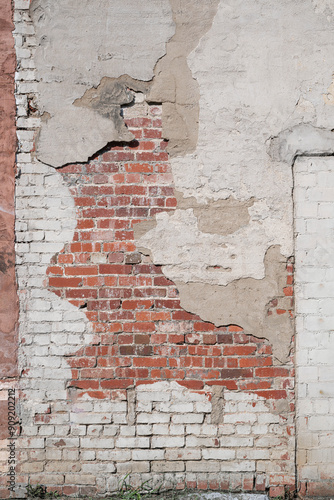 Empty old grunge red stone brick wall background.  Abstract painted distressed surface.  Shabby building facade with copy space.