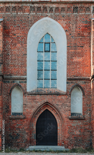 Side entrance including windows to the church with Gothic architecture. 