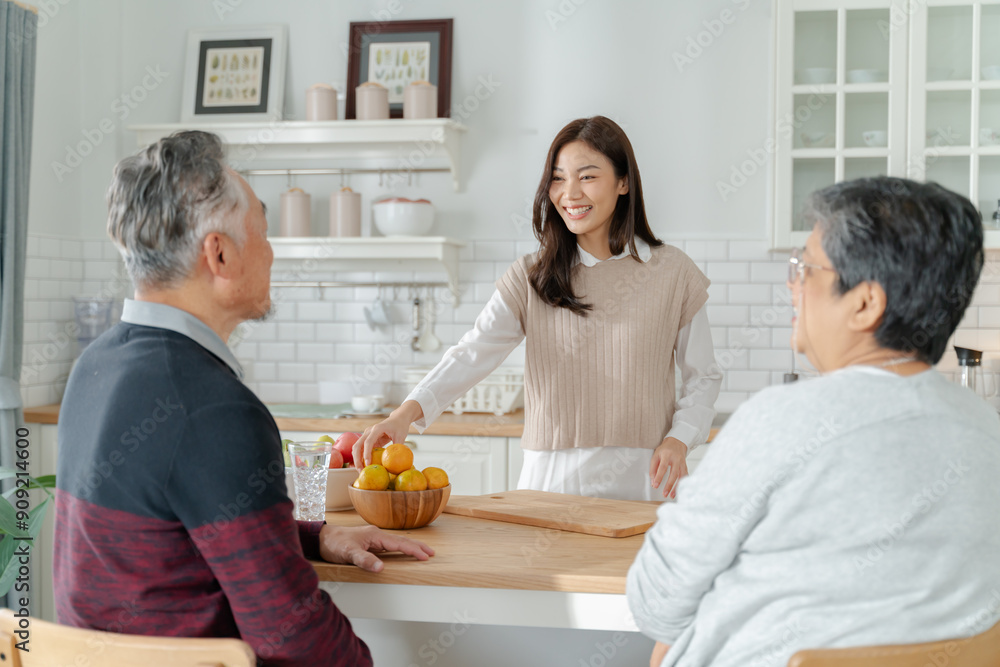 Asian lovely family,young daughter look to old mother and dad cook in kitchen.asian female enjoy spend leisure time senior elderly mom make breakfast on table in house.Activity family relationship Asian lovely family,young daughter look to old mother and dad cook in kitchen.asian female enjoy spend leisure time senior elderly mom make breakfast on table in house.Activity family relationship
