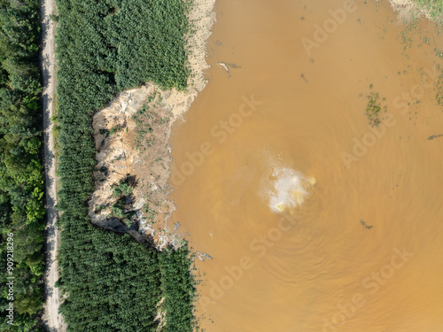 Aerial drone view of flooded sand pit. Forest submerged in a lake. Sunken sandpit with clear water.Lake District, swallow hole flooded as a result of the mining damage Pomorzany mine in Olkusz,Poland photo