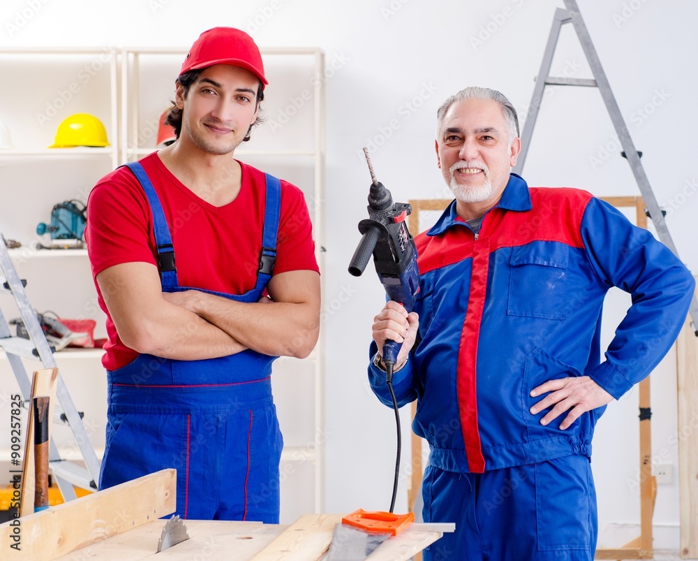 Two professional contractors laying flooring at home Two professional contractors laying flooring at home
