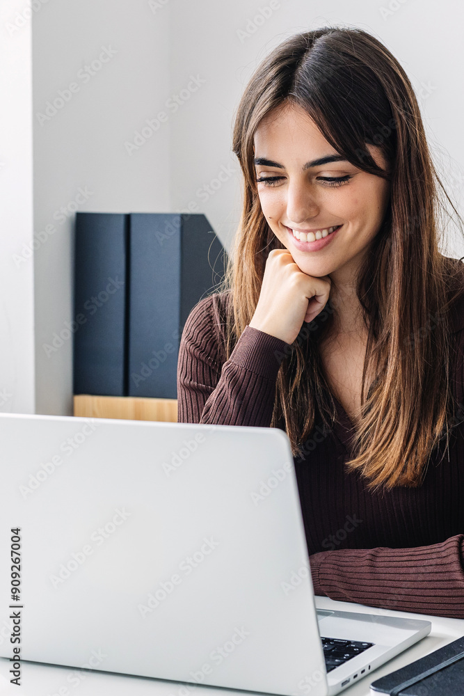 Vertical shot of young student woman studying online from home. Millennial girl listening teacher on laptop training class video conference call. Vertical shot of young student woman studying online from home. Millennial girl listening teacher on laptop training class video conference call.