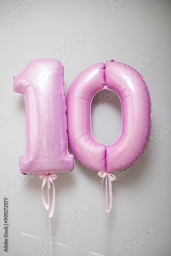 pink foil number 10 balloons on white background