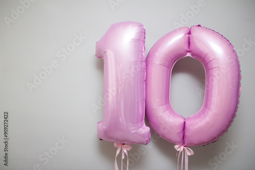 pink foil number 10 balloons on white background