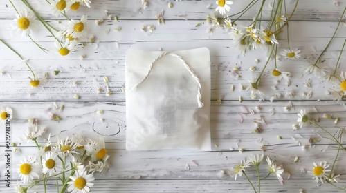 Chamomile tea bag on white wood Close up view space for text natural healing concept